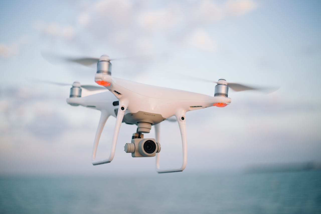 our-story Aerial view of a modern drone flying above the ocean during the day.