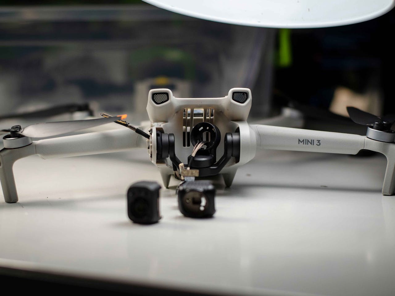 about-img A DJI Mini 3 drone disassembled on a table, showcasing repair and engineering.